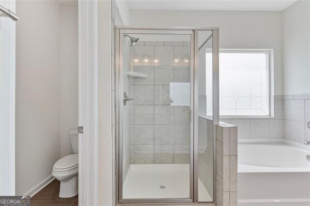 3390 Meadow Grass Dr, Dacula, GA 30019 - bathroom featuring a bath and a shower stall