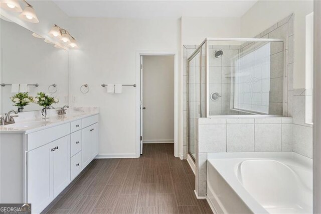 3390 Meadow Grass Dr, Dacula, GA 30019 - bathroom with a garden tub, double vanity, and a stall shower