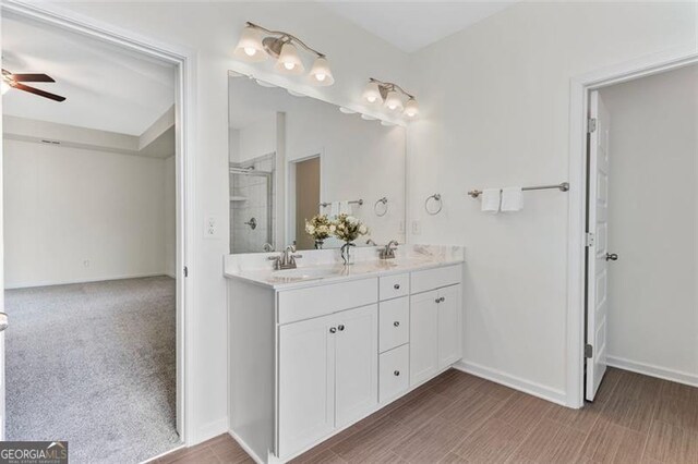 3390 Meadow Grass Dr, Dacula, GA 30019 - full bathroom featuring double vanity, a shower stall, and a ceiling fan