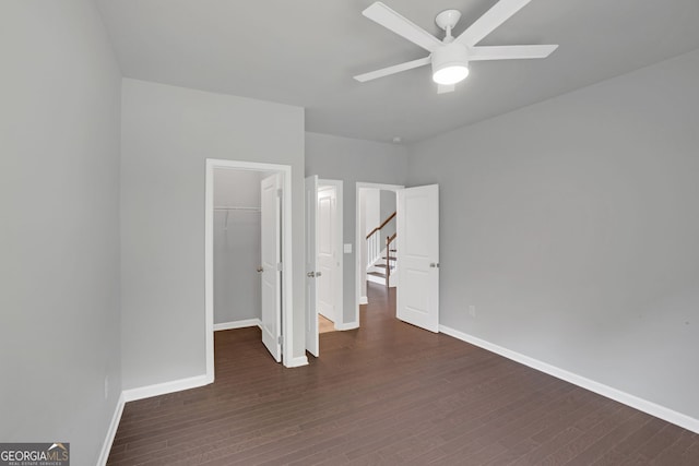 7043 Lancaster Xing, Flowery Branch, GA 30542 - unfurnished bedroom with wood finished floors, a spacious closet, a closet, and ceiling fan