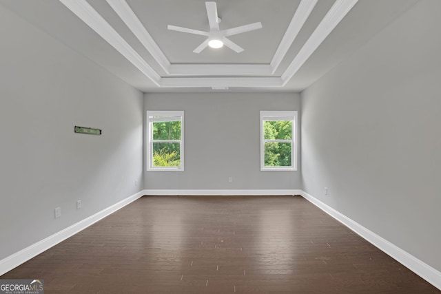 7043 Lancaster Xing, Flowery Branch, GA 30542 - unfurnished room featuring a tray ceiling, plenty of natural light, dark wood-style floors, a ceiling fan, and ornamental molding