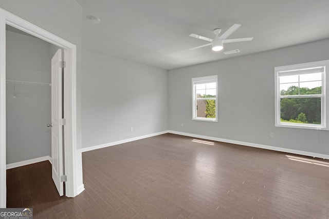 7043 Lancaster Xing, Flowery Branch, GA 30542 - unfurnished bedroom with dark wood-style flooring, a closet, and ceiling fan