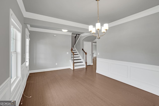 7043 Lancaster Xing, Flowery Branch, GA 30542 - unfurnished room featuring stairs, a chandelier, a wainscoted wall, ornamental molding, and a decorative wall