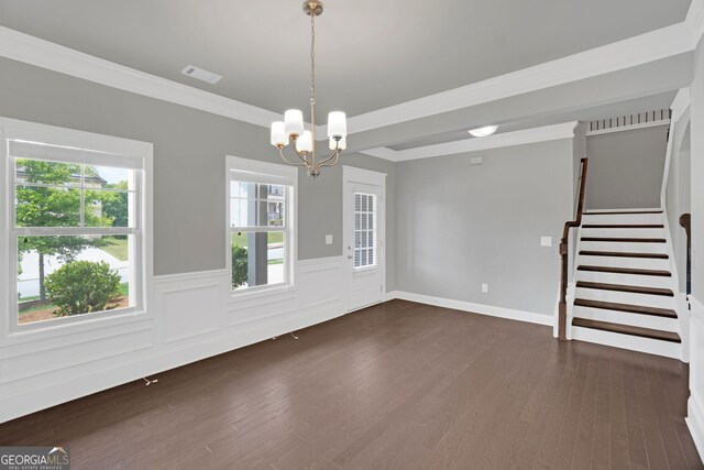 7043 Lancaster Xing, Flowery Branch, GA 30542 - unfurnished room with a chandelier, dark wood-style floors, a wainscoted wall, stairs, and crown molding