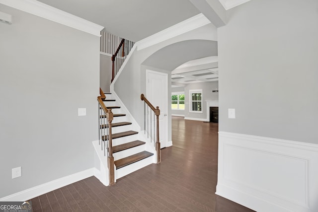 7043 Lancaster Xing, Flowery Branch, GA 30542 - stairs with arched walkways, wood finished floors, ornamental molding, a fireplace, and beamed ceiling