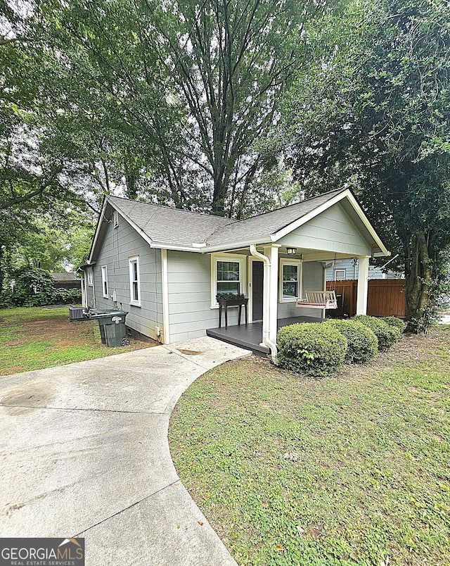1341 SE Joyner Ave SE, Marietta, GA 30060 - view of front of house featuring a porch, driveway, and roof with shingles