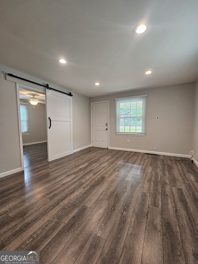 1341 SE Joyner Ave SE, Marietta, GA 30060 - empty room featuring a barn door, dark wood finished floors, and recessed lighting