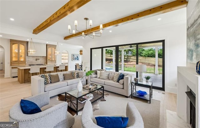 1312 Becket Dr NE, Brookhaven, GA 30319 - living room with a chandelier, light wood-style flooring, recessed lighting, arched walkways, and beam ceiling