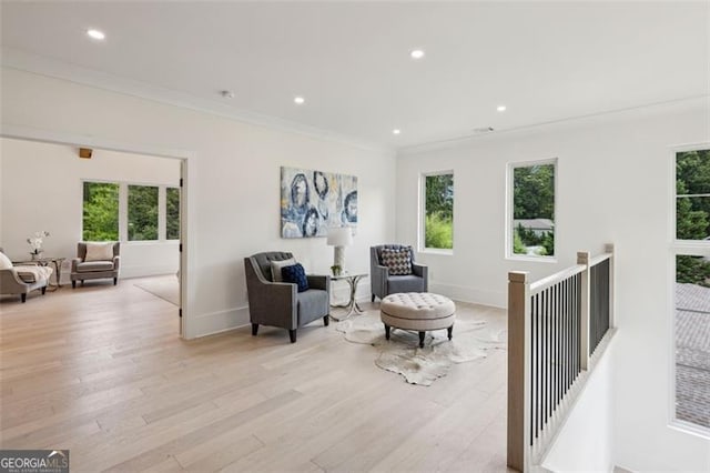 1312 Becket Dr NE, Brookhaven, GA 30319 - living area featuring healthy amount of natural light, light wood-style flooring, recessed lighting, ornamental molding, and an upstairs landing
