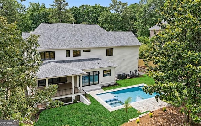 1312 Becket Dr NE, Brookhaven, GA 30319 - rear view of house with a yard, roof with shingles, a pool with connected hot tub, and a patio