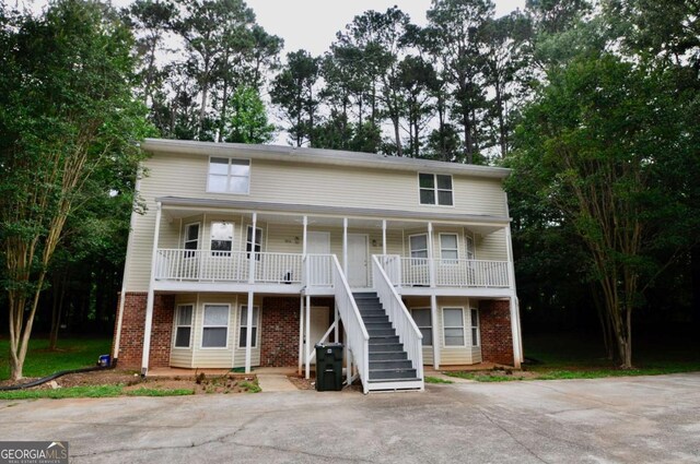 1824 Cedar Shoals Dr, Athens, GA 30605 - view of front facade with stairs, a porch, and brick siding