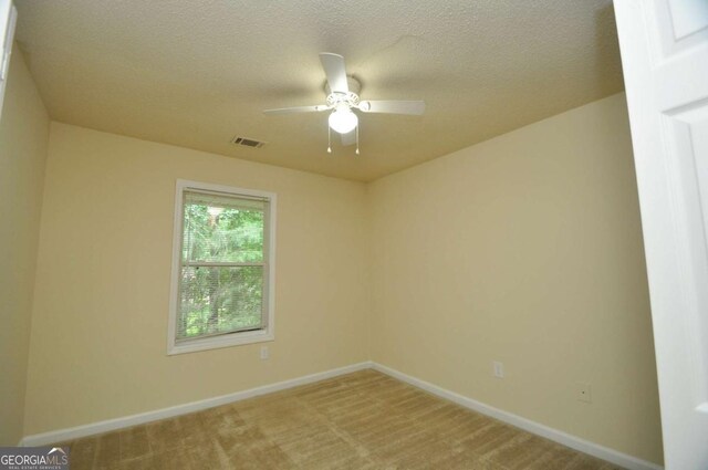 1824 Cedar Shoals Dr, Athens, GA 30605 - unfurnished room with light carpet, a ceiling fan, and a textured ceiling