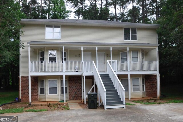 1824 Cedar Shoals Dr, Athens, GA 30605 - townhome / multi-family property with brick siding, a porch, and stairway