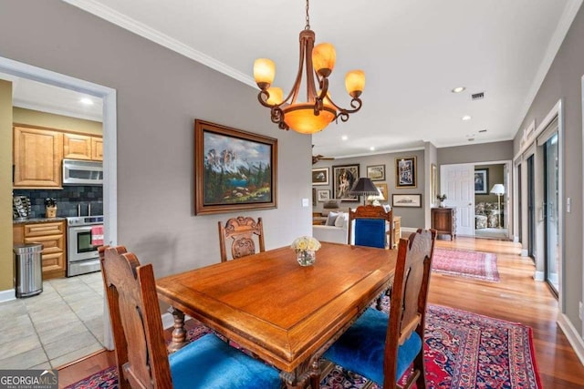 3071 Lenox Rd NE Unit 19, Atlanta, GA 30324 - dining space featuring a chandelier, crown molding, recessed lighting, and light wood-type flooring