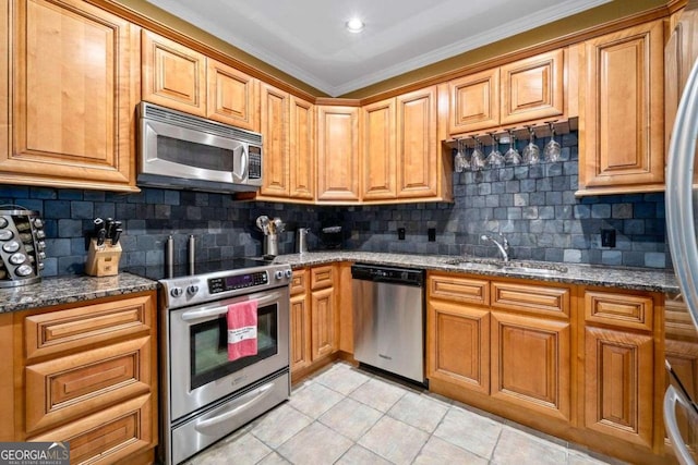 3071 Lenox Rd NE Unit 19, Atlanta, GA 30324 - kitchen featuring appliances with stainless steel finishes, light tile patterned floors, dark stone counters, decorative backsplash, and crown molding