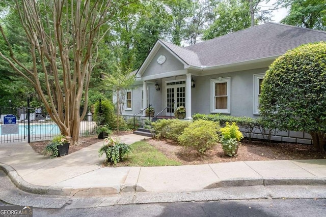 3071 Lenox Rd NE Unit 19, Atlanta, GA 30324 - single story home featuring stucco siding, french doors, a shingled roof, and a community pool
