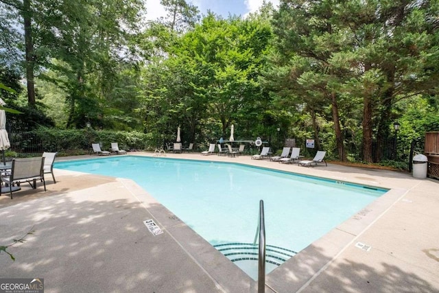 3071 Lenox Rd NE Unit 19, Atlanta, GA 30324 - community pool with a patio and view of wooded area