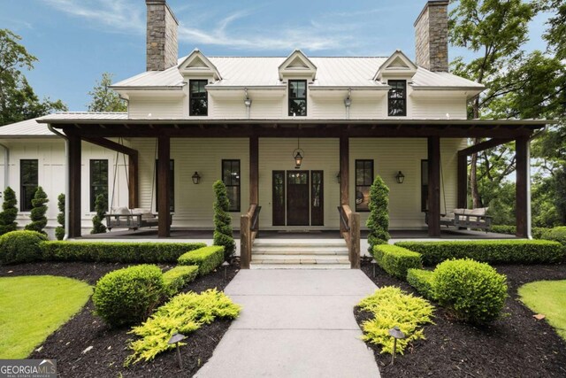 13365 Hopewell Rd, Alpharetta, GA 30004 - view of front of house featuring a chimney, a porch, and a metal roof
