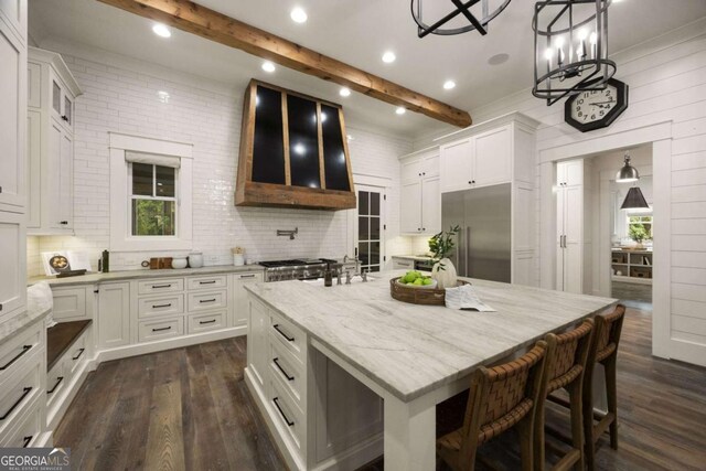 13365 Hopewell Rd, Alpharetta, GA 30004 - kitchen with built in fridge, dark wood-type flooring, healthy amount of natural light, white cabinetry, and beam ceiling