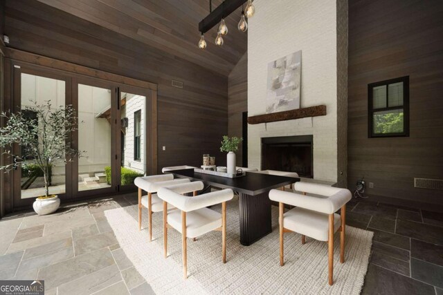 13365 Hopewell Rd, Alpharetta, GA 30004 - interior space featuring wooden walls, stone tile floors, high vaulted ceiling, and an outdoor brick fireplace