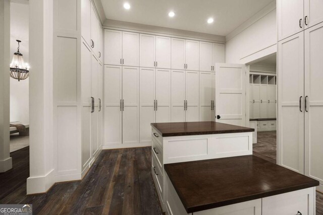 13365 Hopewell Rd, Alpharetta, GA 30004 - walk in closet featuring dark wood-type flooring and a chandelier