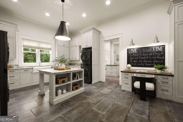 13365 Hopewell Rd, Alpharetta, GA 30004 - kitchen with stacked washer / drying machine, open shelves, crown molding, recessed lighting, and a kitchen island