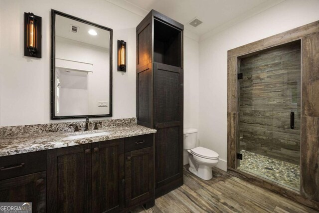 13365 Hopewell Rd, Alpharetta, GA 30004 - full bathroom with wood finished floors, vanity, a stall shower, and ornamental molding