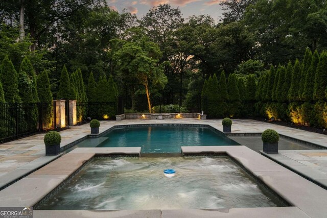 13365 Hopewell Rd, Alpharetta, GA 30004 - view of swimming pool with a pool with connected hot tub and a fenced backyard