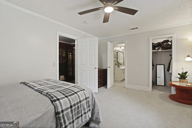 684 Frances Ln, Brooklet, GA 30415 - bedroom featuring a walk in closet, ornamental molding, light carpet, a closet, and ensuite bathroom