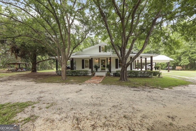 684 Frances Ln, Brooklet, GA 30415 - view of front facade with a porch, a detached carport, and a front lawn