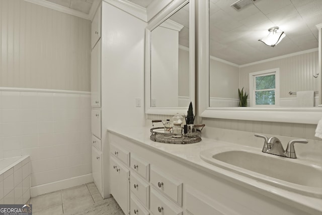 684 Frances Ln, Brooklet, GA 30415 - bathroom with double vanity, tile patterned floors, tile walls, and ornamental molding