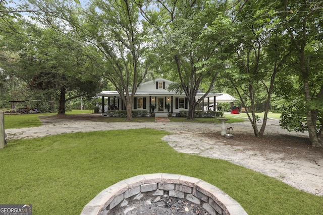 684 Frances Ln, Brooklet, GA 30415 - view of green lawn with a porch and a fire pit