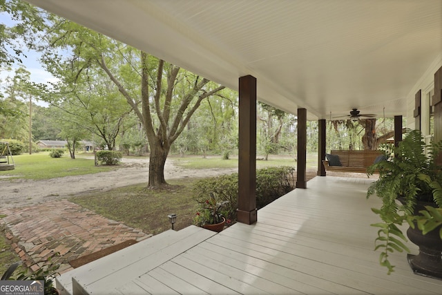 684 Frances Ln, Brooklet, GA 30415 - wooden porch featuring a ceiling fan and a lawn