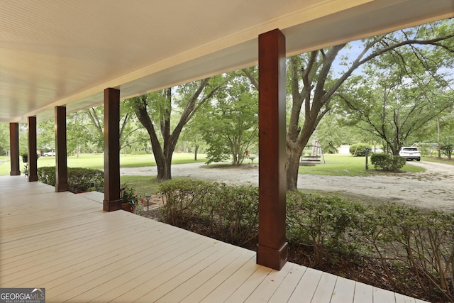684 Frances Ln, Brooklet, GA 30415 - wooden porch featuring a lawn and view of wooded area