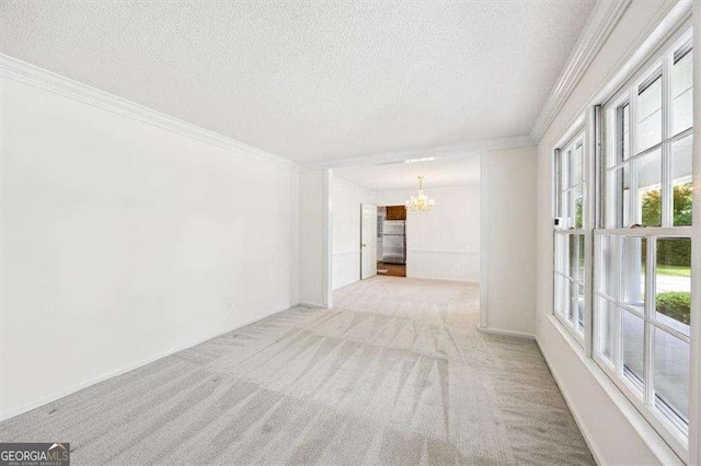 204 Old Oak Rd, Macon, GA 31216 - spare room with a chandelier, a textured ceiling, ornamental molding, and carpet floors