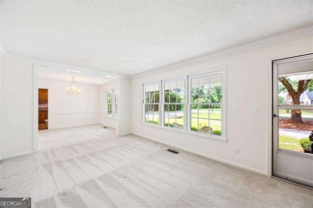 204 Old Oak Rd, Macon, GA 31216 - unfurnished living room featuring ornamental molding, a chandelier, carpet flooring, a textured ceiling, and healthy amount of natural light