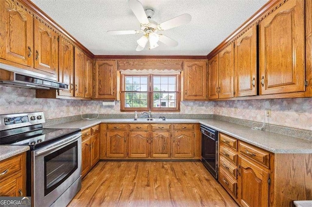 204 Old Oak Rd, Macon, GA 31216 - kitchen featuring stainless steel range with electric stovetop, under cabinet range hood, dishwasher, brown cabinetry, and a textured ceiling