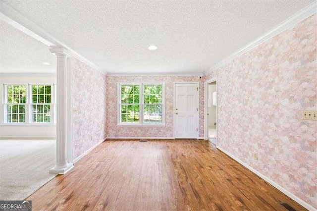 204 Old Oak Rd, Macon, GA 31216 - unfurnished room with crown molding, wood finished floors, decorative columns, a textured ceiling, and wallpapered walls