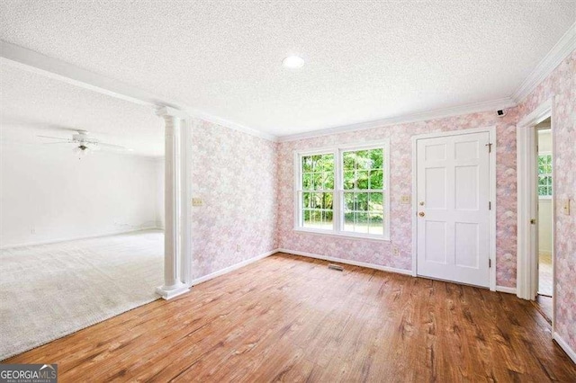 204 Old Oak Rd, Macon, GA 31216 - foyer featuring a textured ceiling, ornamental molding, ornate columns, healthy amount of natural light, and wood finished floors
