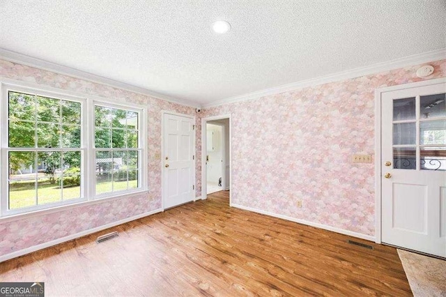 204 Old Oak Rd, Macon, GA 31216 - entrance foyer featuring crown molding, a textured ceiling, wallpapered walls, and wood finished floors