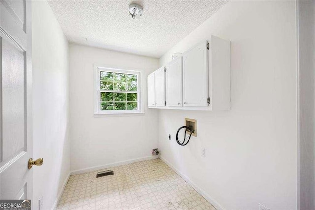 204 Old Oak Rd, Macon, GA 31216 - laundry room featuring light floors, cabinet space, washer hookup, a textured ceiling, and electric dryer hookup