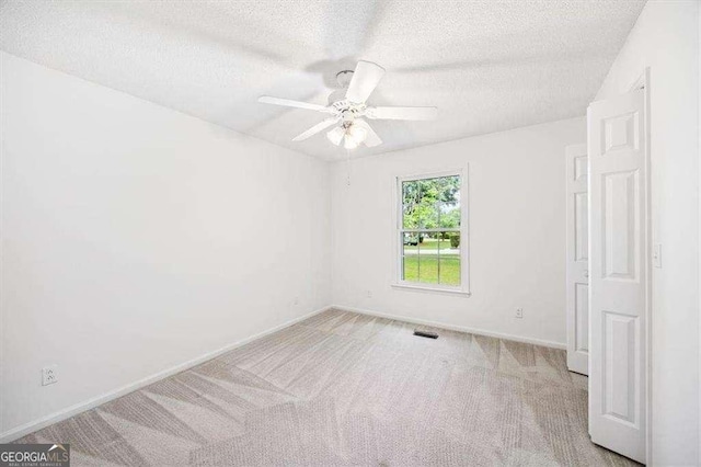 204 Old Oak Rd, Macon, GA 31216 - carpeted empty room with a textured ceiling and ceiling fan