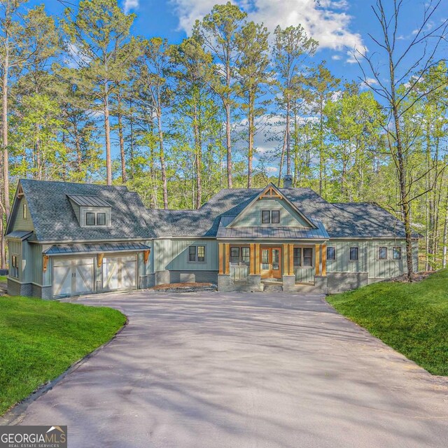 1281 Snug Harbor Dr, Greensboro, GA 30642 - view of front of property featuring driveway, covered porch, a front lawn, a garage, and a chimney