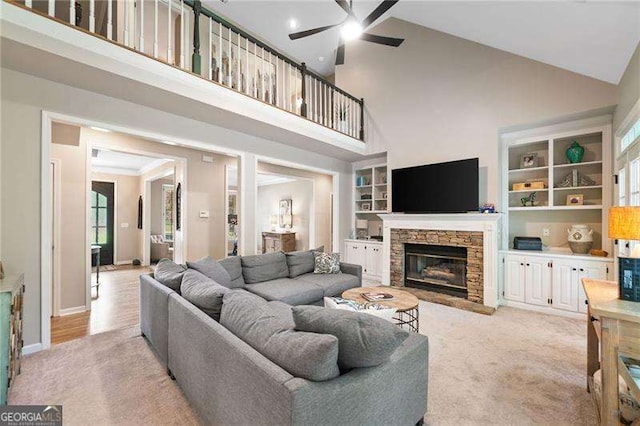 501 Avery Creek Pointe, Woodstock, GA 30188 - living room featuring high vaulted ceiling, a ceiling fan, a fireplace, and light colored carpet
