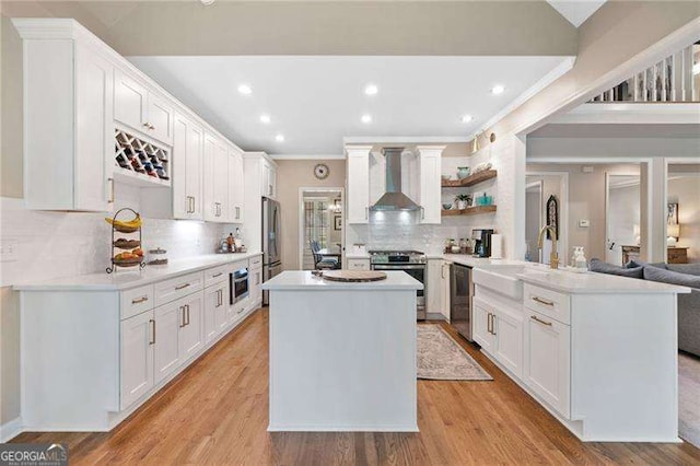 501 Avery Creek Pointe, Woodstock, GA 30188 - kitchen with wall chimney exhaust hood, stainless steel appliances, crown molding, a peninsula, and tasteful backsplash