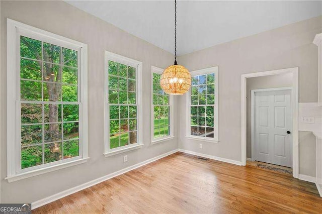 501 Avery Creek Pointe, Woodstock, GA 30188 - unfurnished dining area featuring a chandelier and wood finished floors