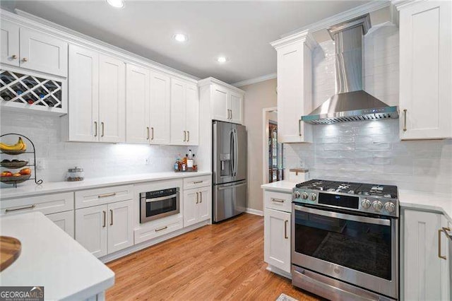 501 Avery Creek Pointe, Woodstock, GA 30188 - kitchen featuring stainless steel appliances, wall chimney exhaust hood, light countertops, backsplash, and recessed lighting