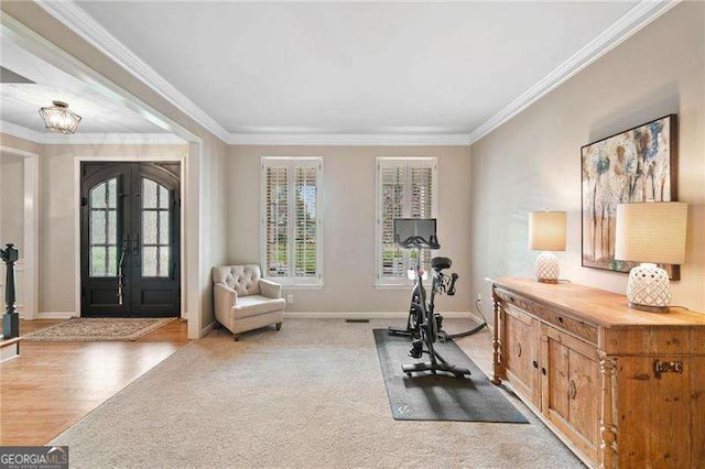501 Avery Creek Pointe, Woodstock, GA 30188 - exercise room with crown molding, french doors, and light wood-type flooring