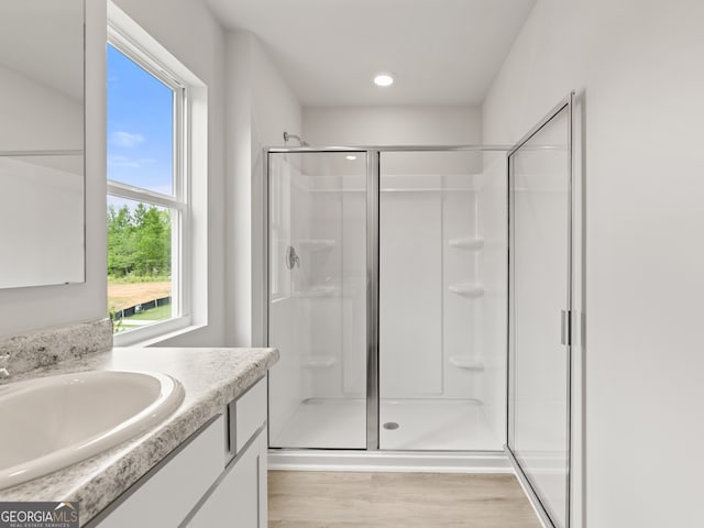 504 Oak View Ln, Dallas, GA 30157 - bathroom featuring a stall shower, wood finished floors, and vanity