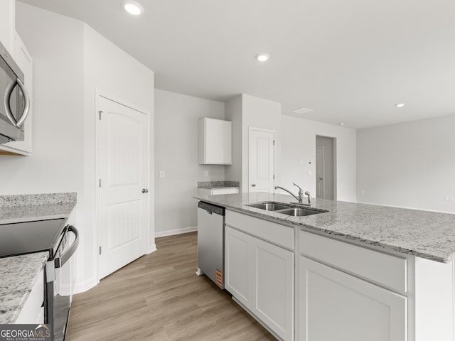 504 Oak View Ln, Dallas, GA 30157 - kitchen with stainless steel appliances, white cabinetry, light wood-style flooring, light stone counters, and recessed lighting